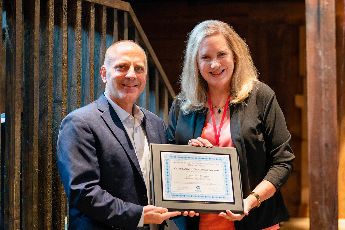A representative from the American Society for Engineering Education presents the organization's Midwest Region Outstanding Teaching Award to Dr. Jennifer Glenn, Associate Professor of Teaching in the School of Industrial Engineering and Management.