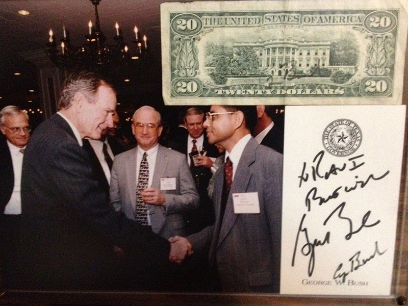 A collage of photos showing a man shaking a former president of the U.S. hand and an American dollar featuring the white house and President Bush's signature.