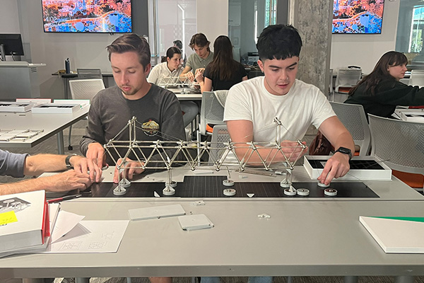 OSU architecture students work with Mola modeling kits. The kits are designed to simulate how real-world scenarios such as earthquakes impact the structural integrity of a building.