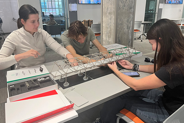 OSU architecture students create a bridge structure using a Mola modeling kit.