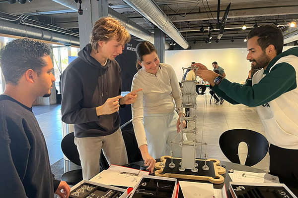 A group of Oklahoma State Univeristy architecture students react joyfully during a workshop with Mola modeling kits.