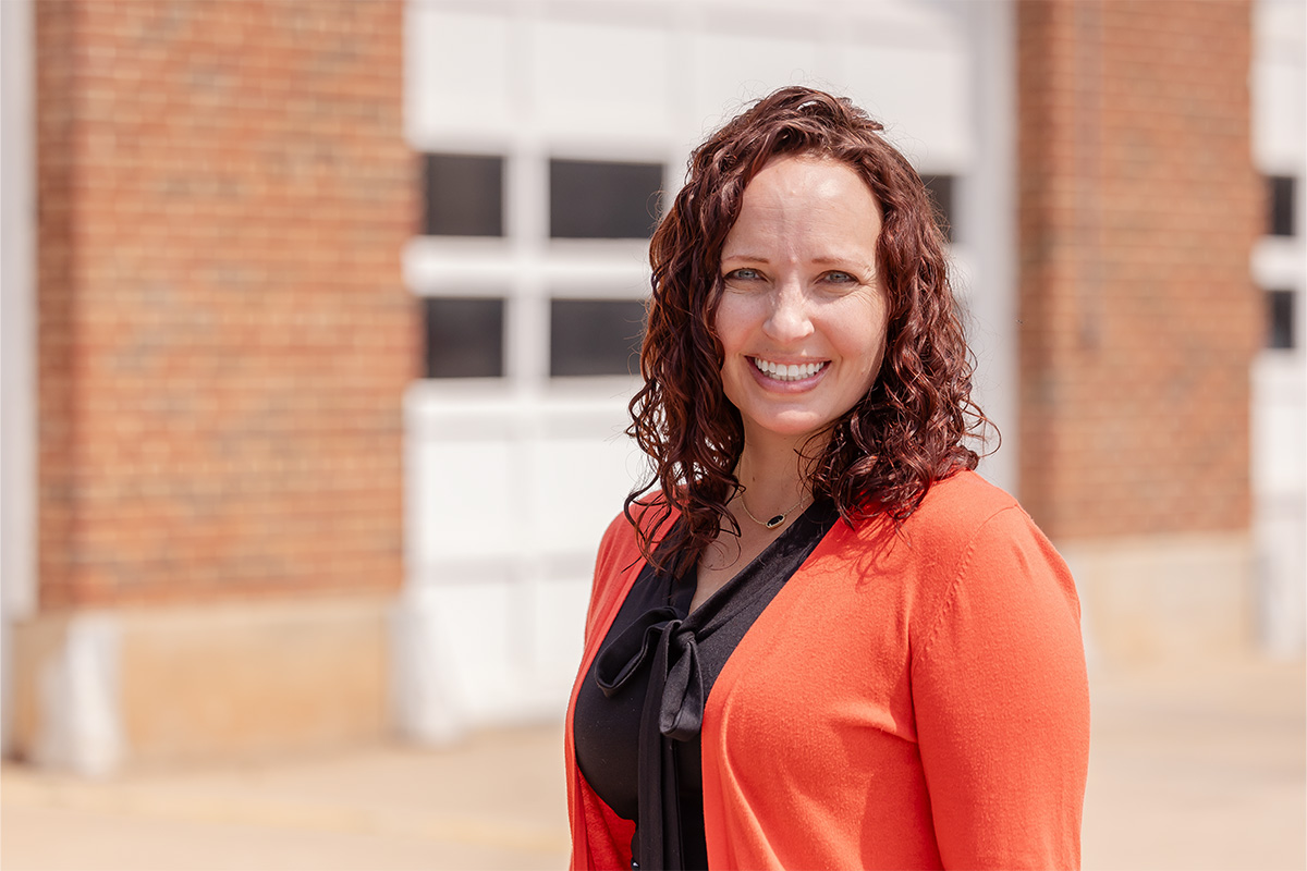 Virginia Charter standing in front of the Campus Fire Station