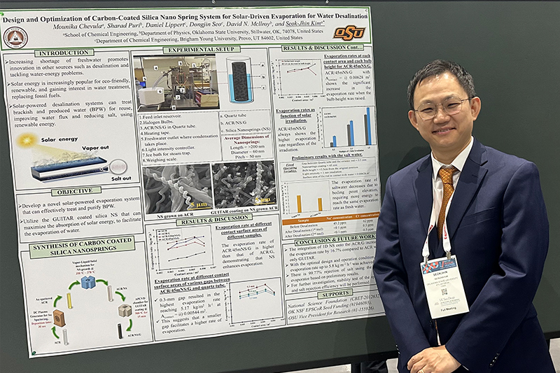 Dr. Kim standing in front of hie research poster smiling