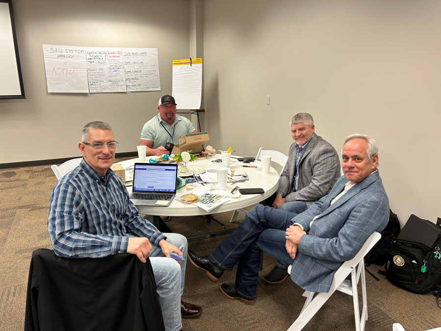 Safe System Approach for All workshop participants seated around a table Safe System Approach for All workshop participants seated around a table