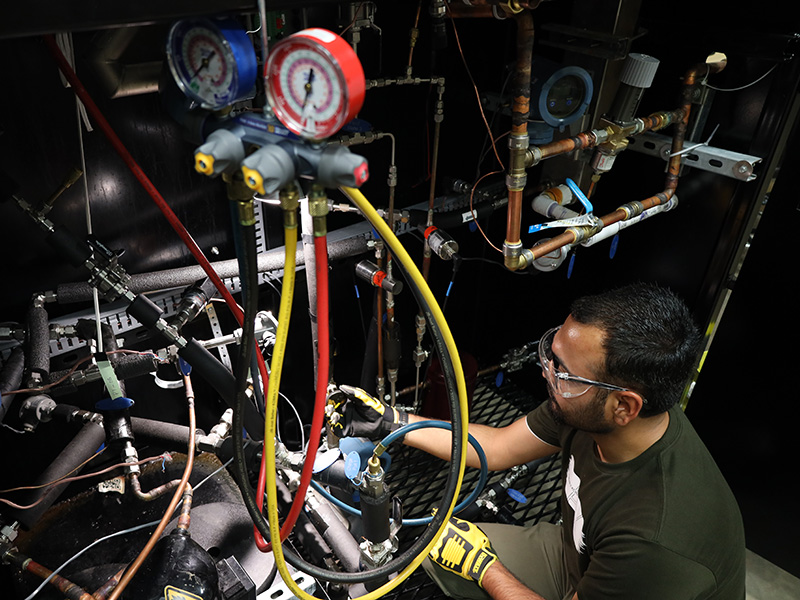 cibs-front-gal-9.jpg CIBS student making adjustments to the vapor compression system within the CIBS lab / Pictured: Muhammad Hasanat Khan