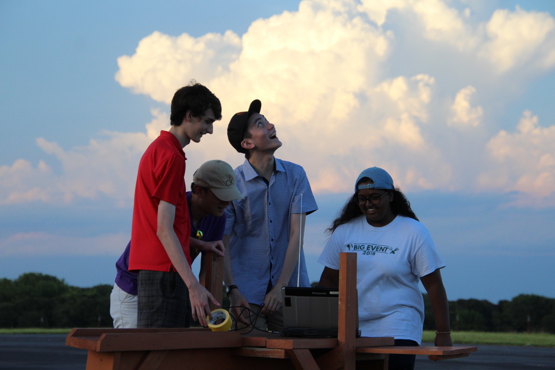 The summer 2019 high school student interns working on a flight project.