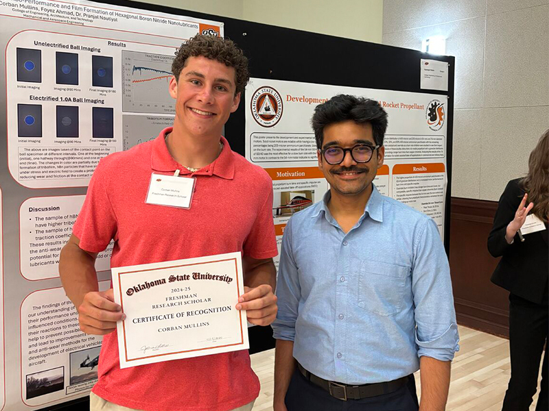 image of Corban Mullins presenting his first research poster at the 2025 Freshman Research Scholars Symposium