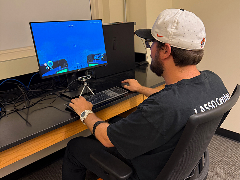 Pictured is an eye tracker and a heart rate monitor collecting physiology data to quantify cognitive behavior in simulated environments