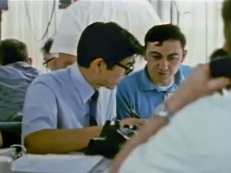 Two men work intensely at a NASA facility.