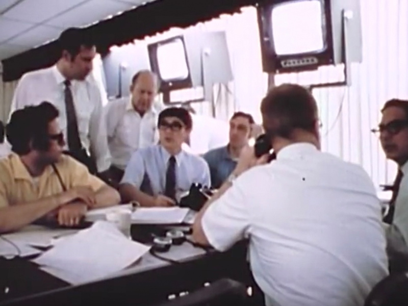 A group of men in the NASA MER room working.