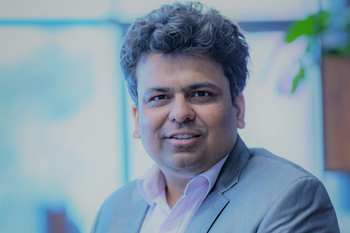 A headshot of a man in a suit.