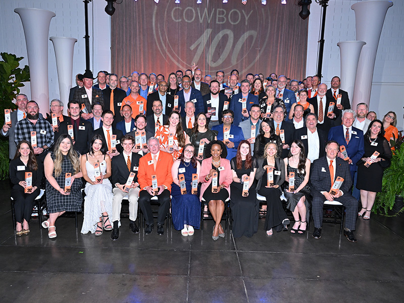 A large group of people all dressed professionaly at an OSU event. 