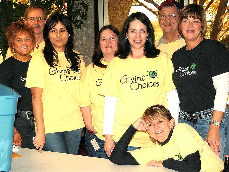 A group photo of smiley people wearing yellow shirts that say A group photo of smiley people wearing yellow shirts that say