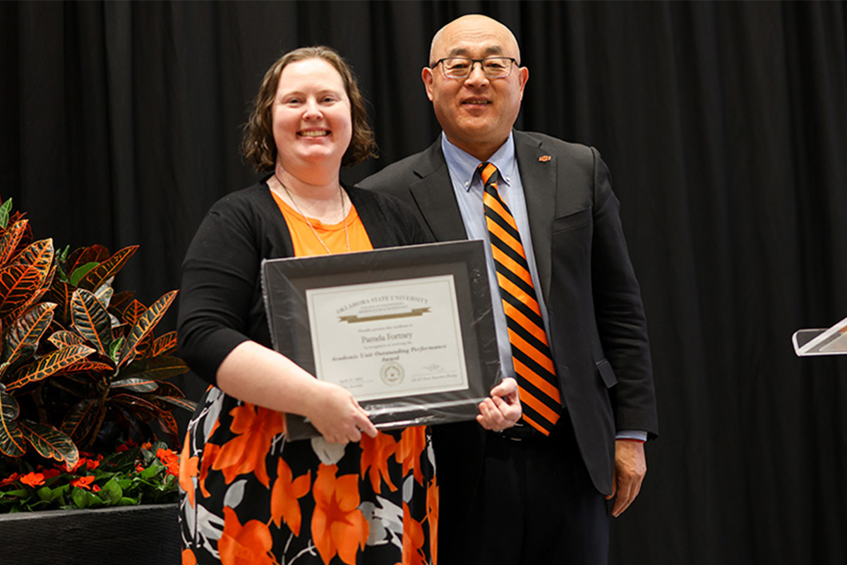 ceat-fss-pamela-fortney.jpg Two individuals standing on stage. One person is holding an award.