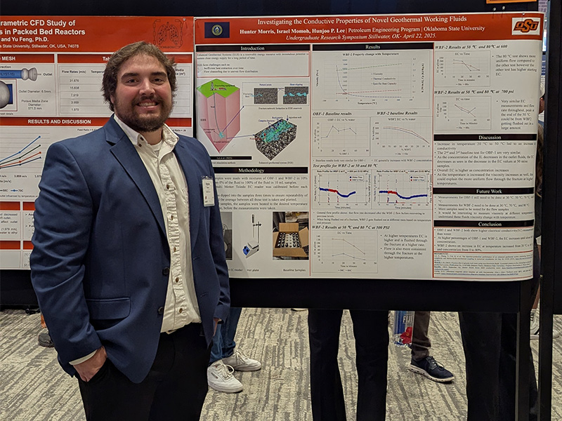 An undergraduate chemical engineering student with their research poster.