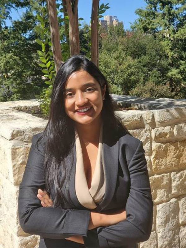 A smiling woman dressed professionally 