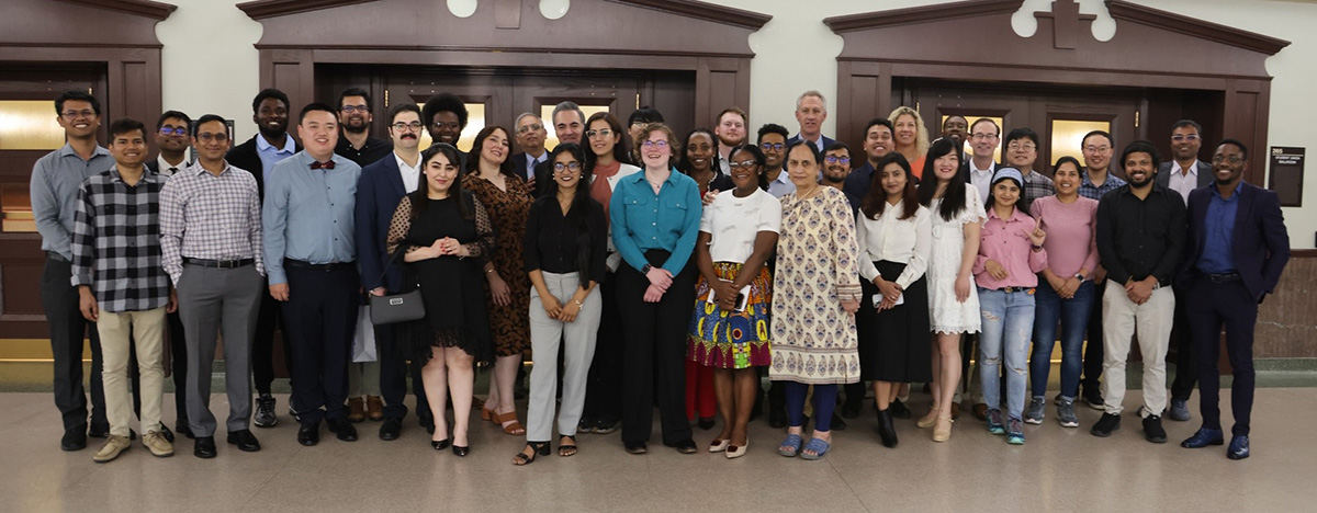 A group of people smile for a portrait photo following a banquet. 