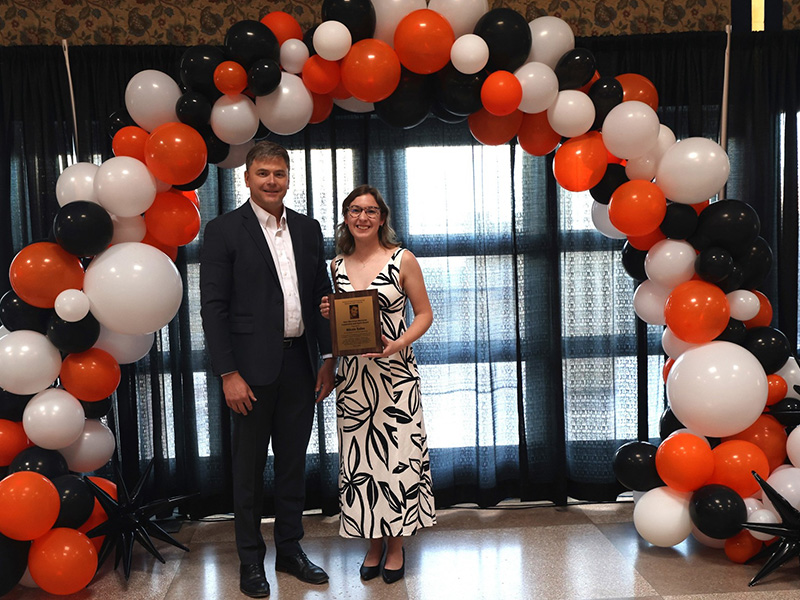 A student smiles after receiving a chemical engineering award. 