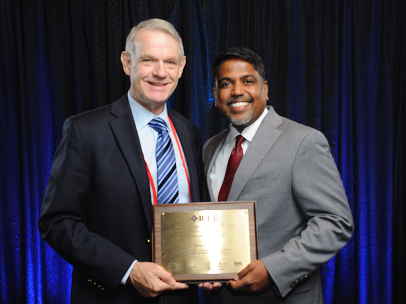 Dr. James West accepts award