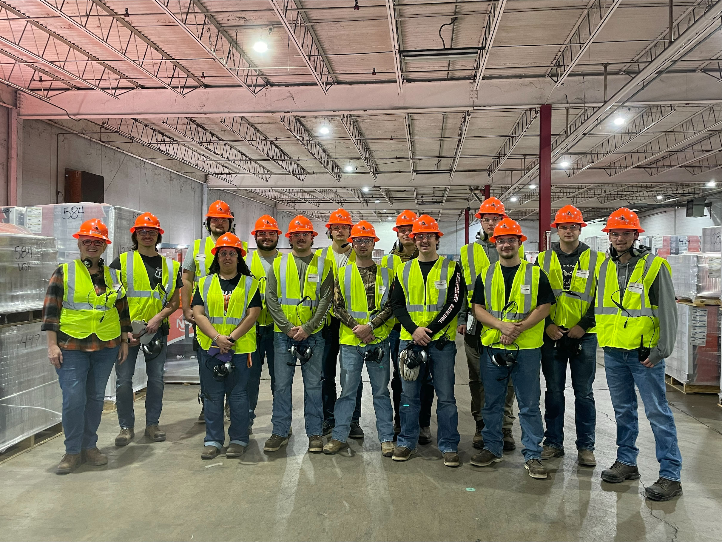 fpset-tour.jpg FPSET studnetnts and instructor wearing high res gear and smiling for a group photo at national standard