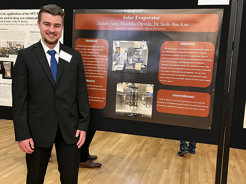 Zach Seay with his poster at the Freshman Research Scholars Symposium