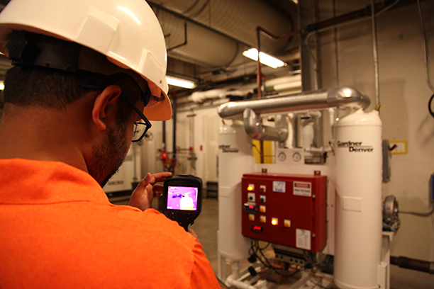 Student using a infrared reader in boiler room