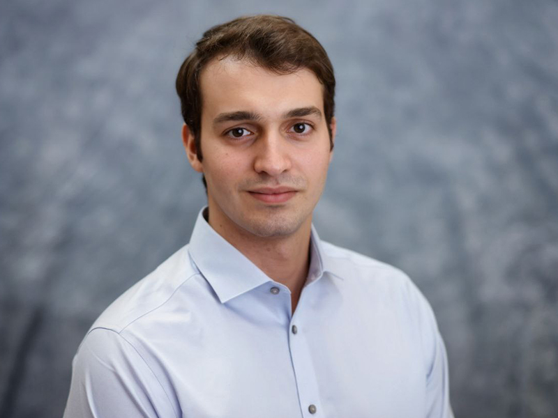 Headshot image of Boris Benedikter wearing a pale blue button down shirt