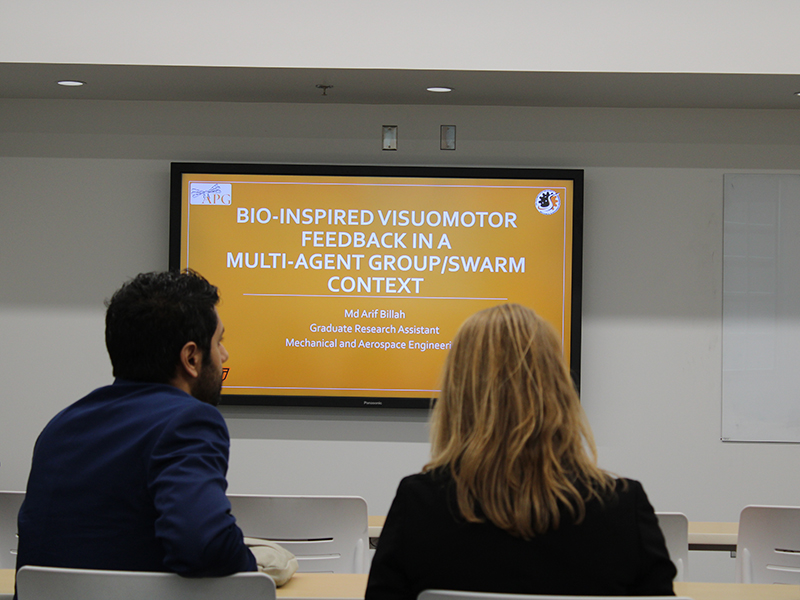 research-filler-symposium-card.jpg Faculty member sitting in on a students presentation