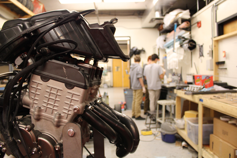 FSAE engine with members in the background