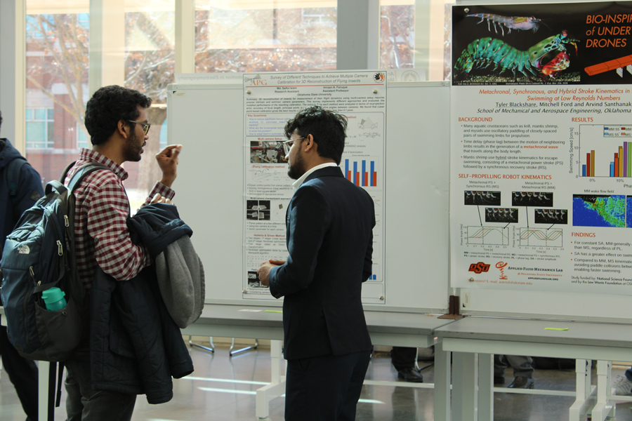 Graduate Students discussing demonstration board