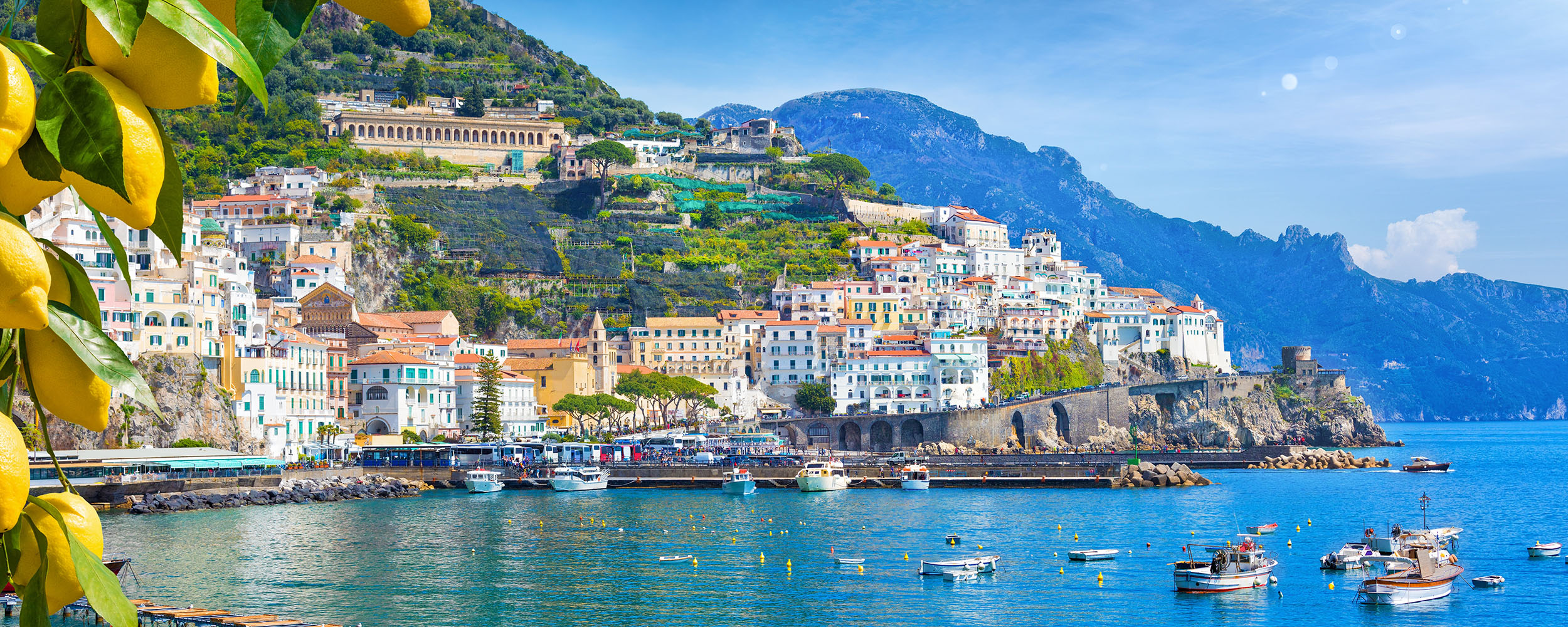Panoramic view of beautiful Amalfi on hills leading down to coast, Campania, Italy.