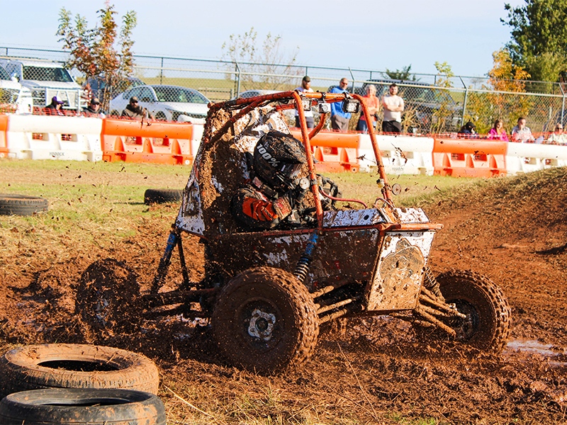 Baja car driving through the mud
